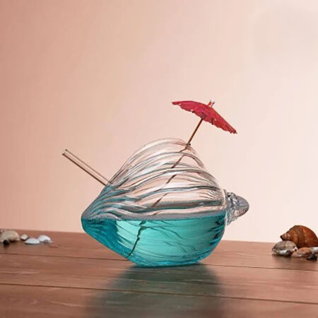 Transparent seashell shaped glass made from hand-blown borosilicate for cocktails and coastal themed drinkware